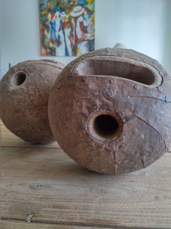 Image of antique wooden bowling balls with a metal cover